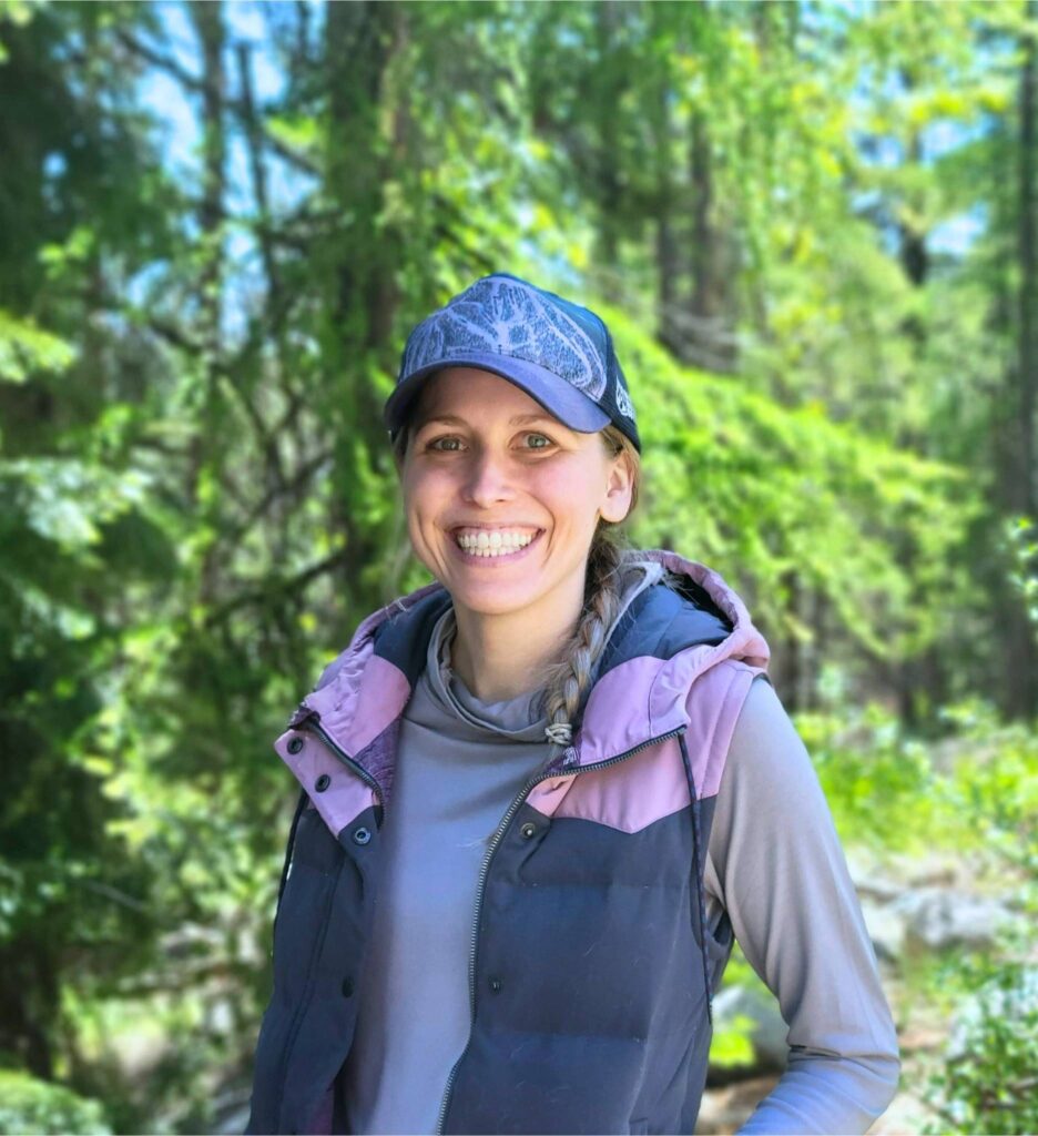 Kimberley of This Purely Joyful Life standing in the forest on a sunny day