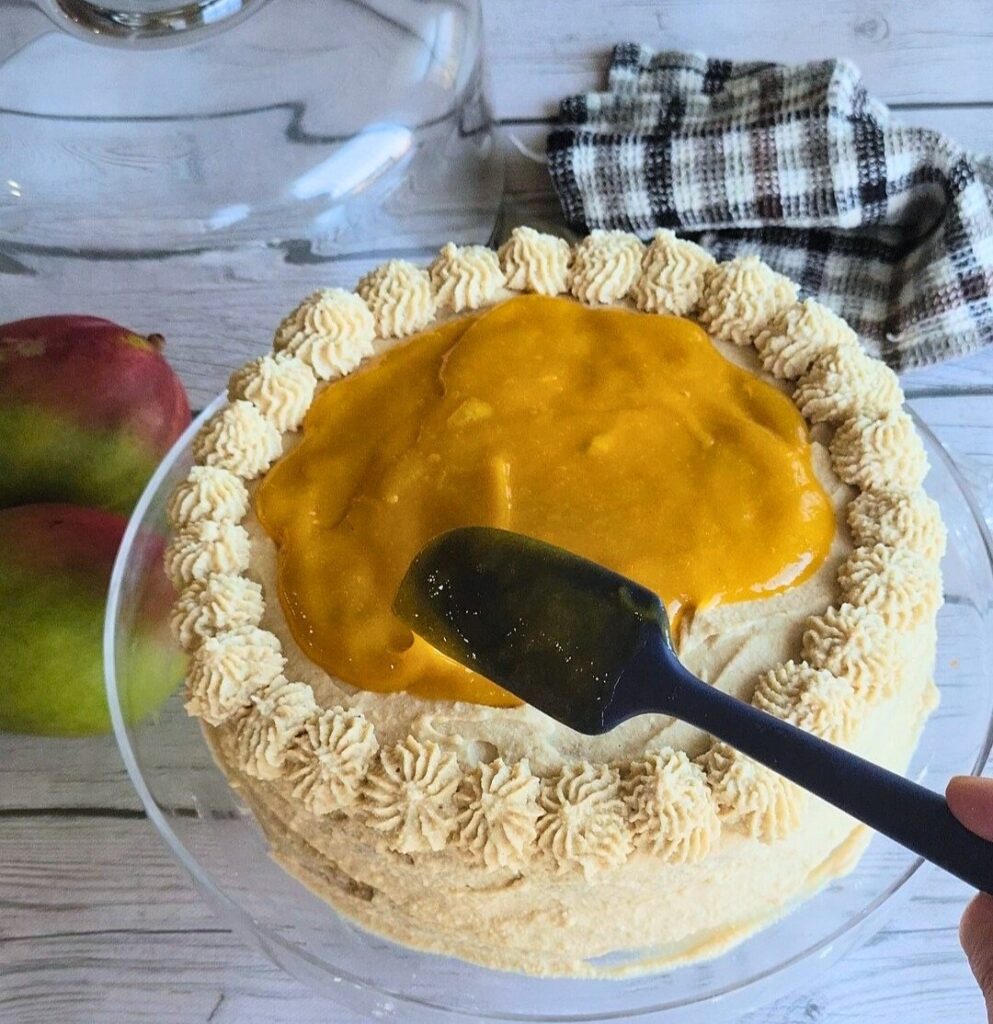 Spreading the filling on the top layer of the gluten-free cake