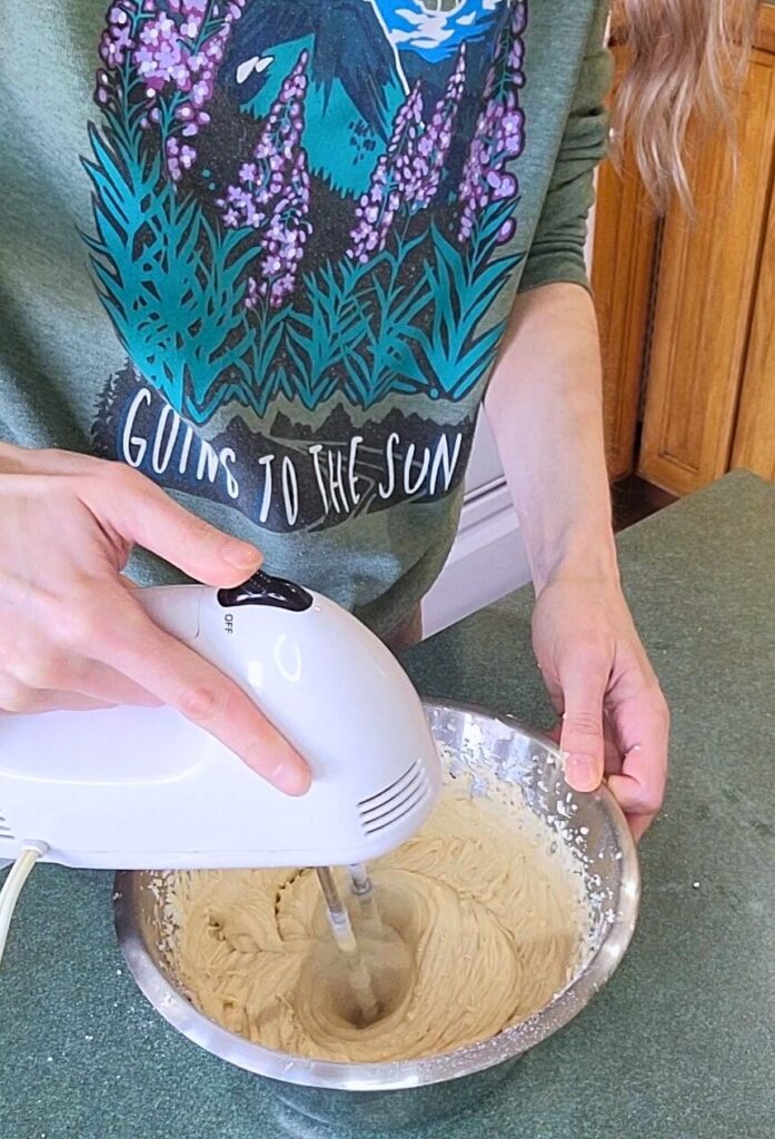 In process mixing the dairy-free coconut cream frosting for the cake