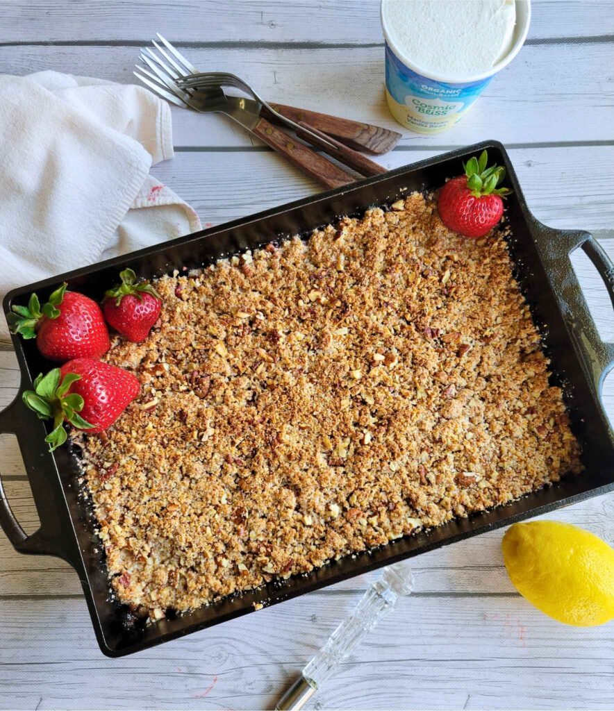 Gluten-free strawberry crumble with fresh strawberries, and ice cream on the side