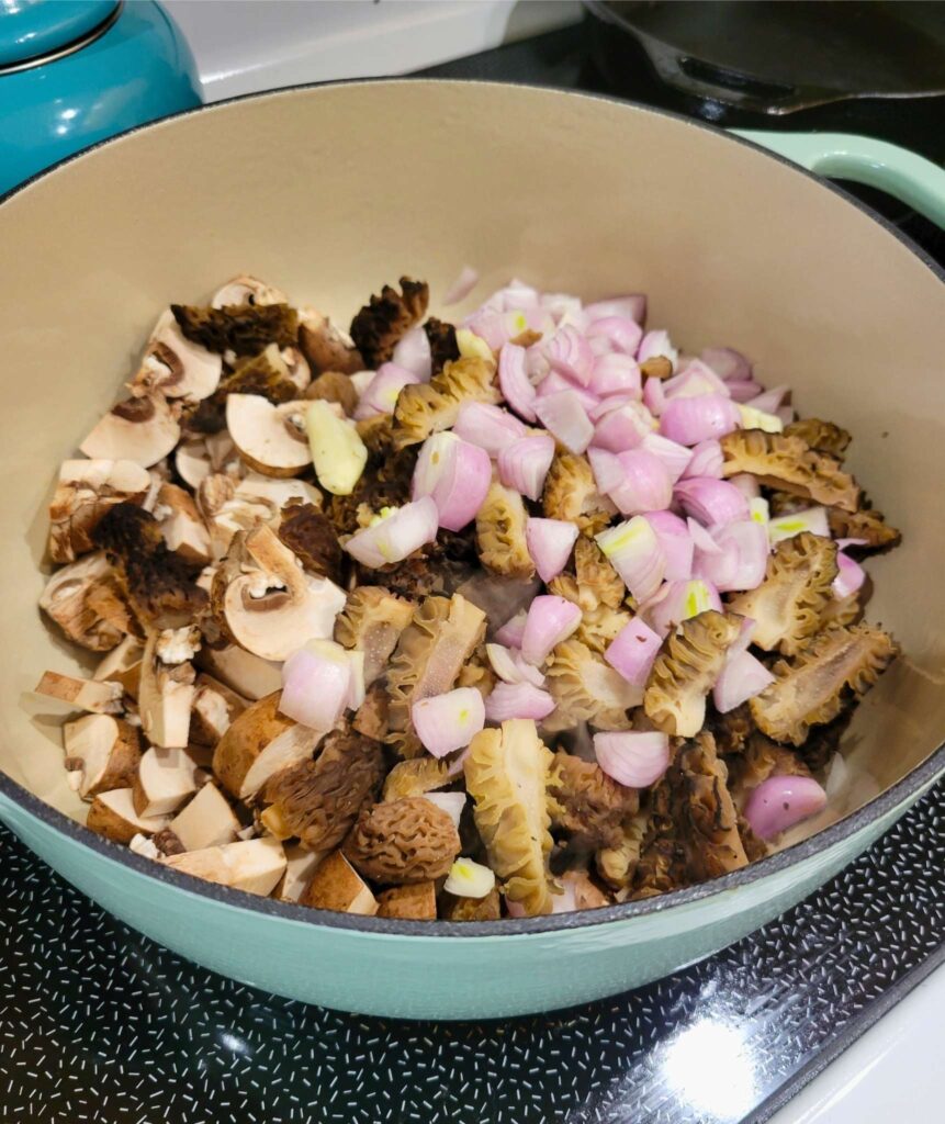 Shallots, Garlic, and Mushrooms Sautéing in a dutch oven