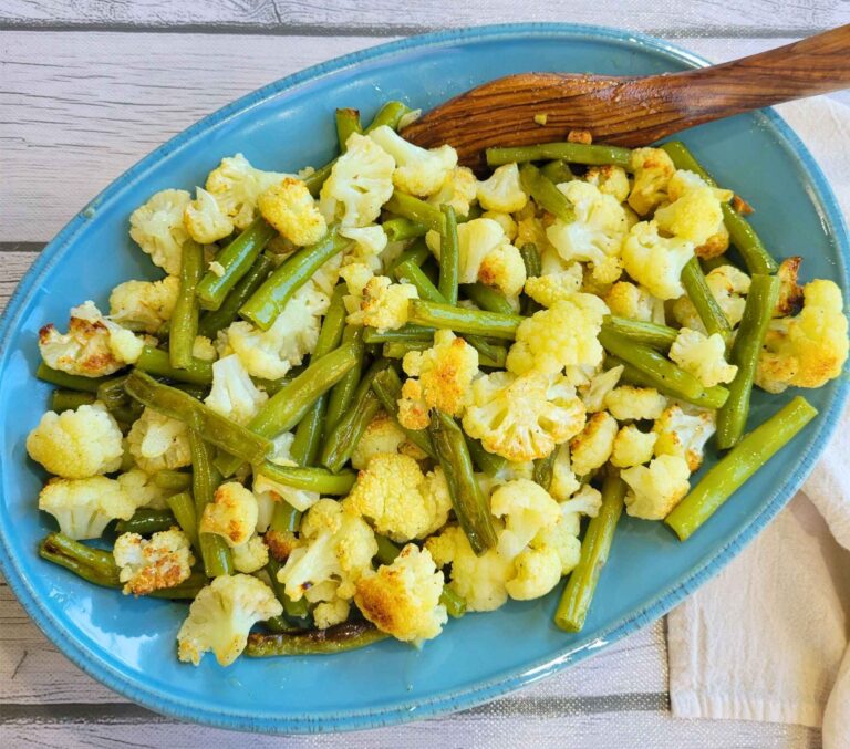 Platter of Garlic Roasted Cauliflower and Green Beans with an olive wood serving spoon