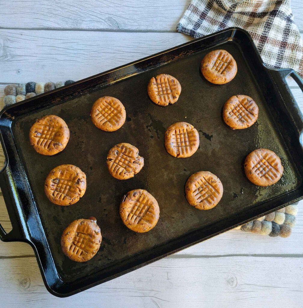 Criss Cross pattern shown on gluten-free peanut butter cookies on a cast iron baking sheet