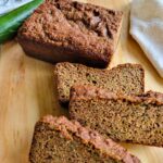 A loaf with a few slices of gluten-free zucchini bread