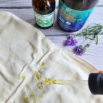 drizzling castor oil on cotton flannel for a castor oil pack