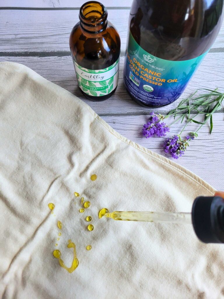 drizzling castor oil on cotton flannel for a castor oil pack