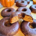 Gluten-free, dairy-free, refined sugar-free pumpkin donuts with a dark chocolate glaze.
