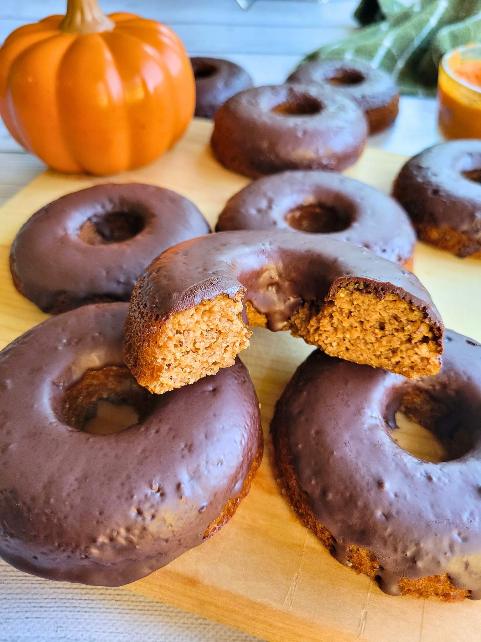 Gluten-free, dairy-free, refined sugar-free pumpkin donuts with a dark chocolate glaze.