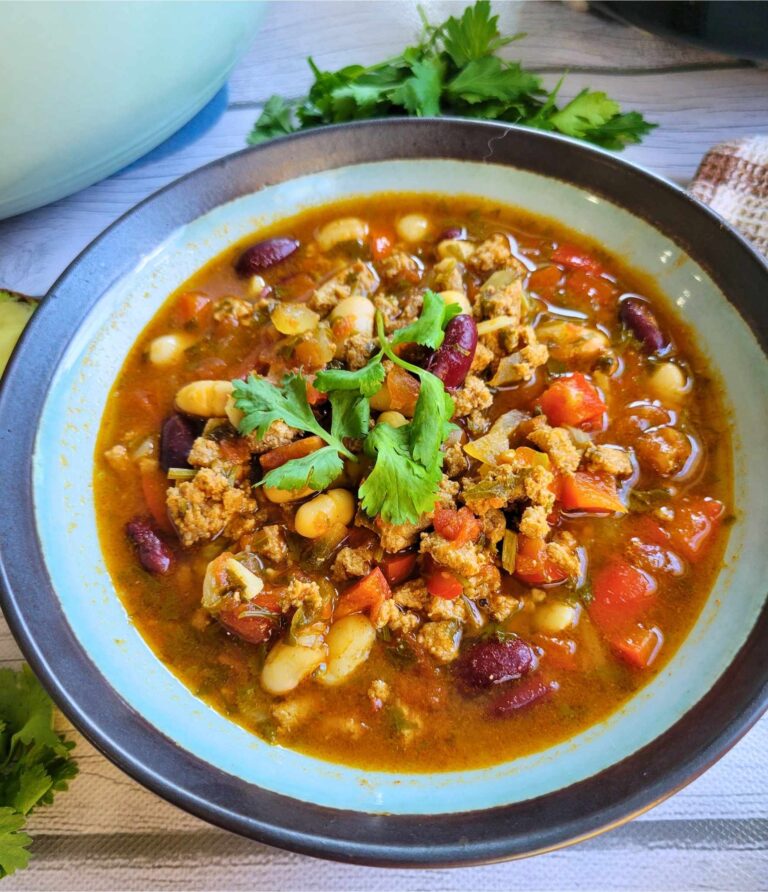 A bowl of anti-inflammatory ground turkey chili topped with cilantro