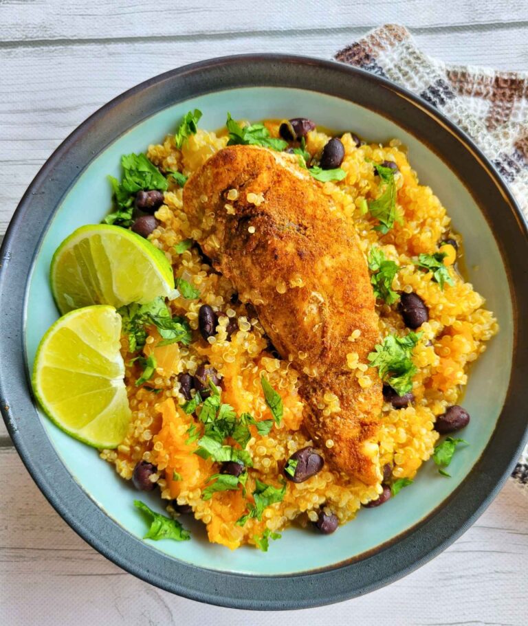 Southwest chicken bowl with butternut squash, quinoa, and cilantro, lime garnish